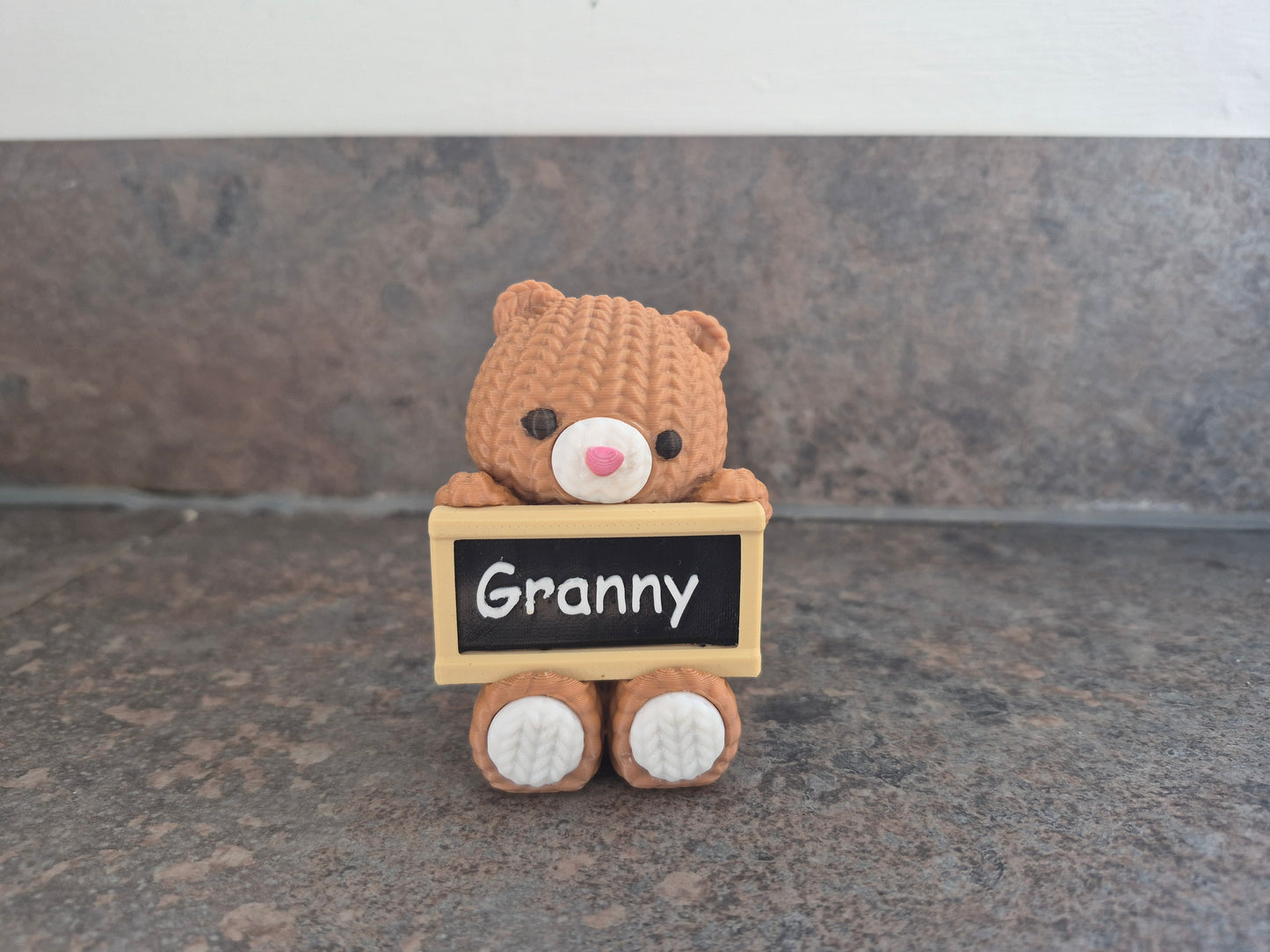 Faux knit bear with sign.