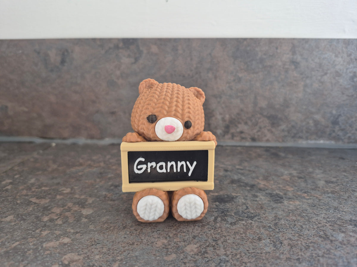 Faux knit bear with sign.