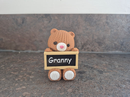 Faux knit bear with sign.